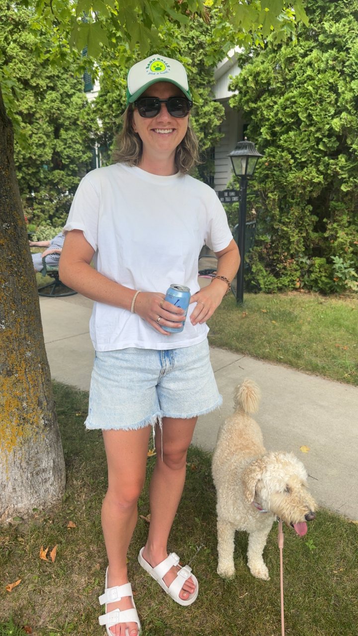 A Bark Baller in a Bark Balls cap out with her doodle on a summer walk