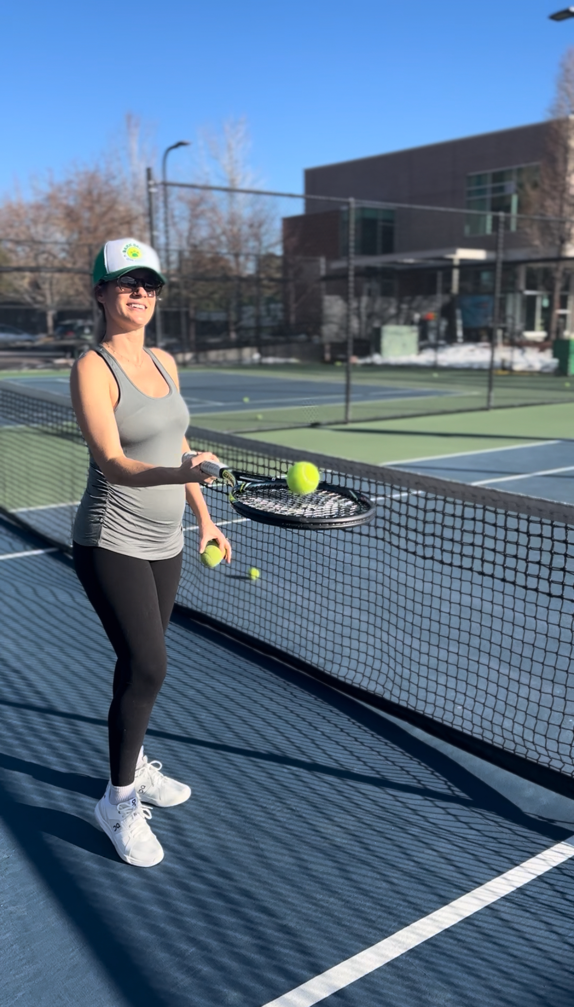 Natalie Ball playing tennis in a Bark Balls hat — founder on the court