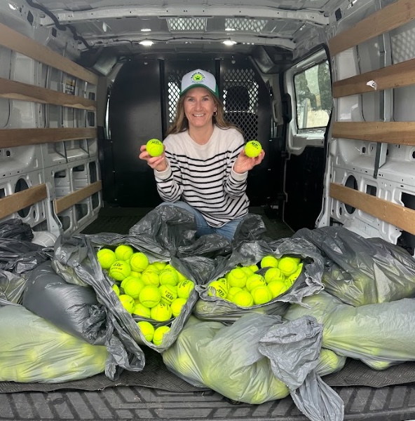 Natalie Ball, founder of Bark Balls, in the van surrounded by bags of collected tennis balls